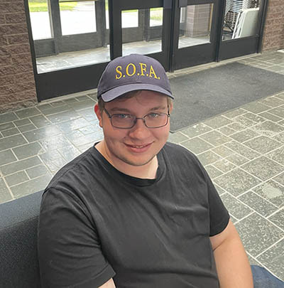 IMAGE #30 – headshot, student wearing SOFA baseball cap copy
